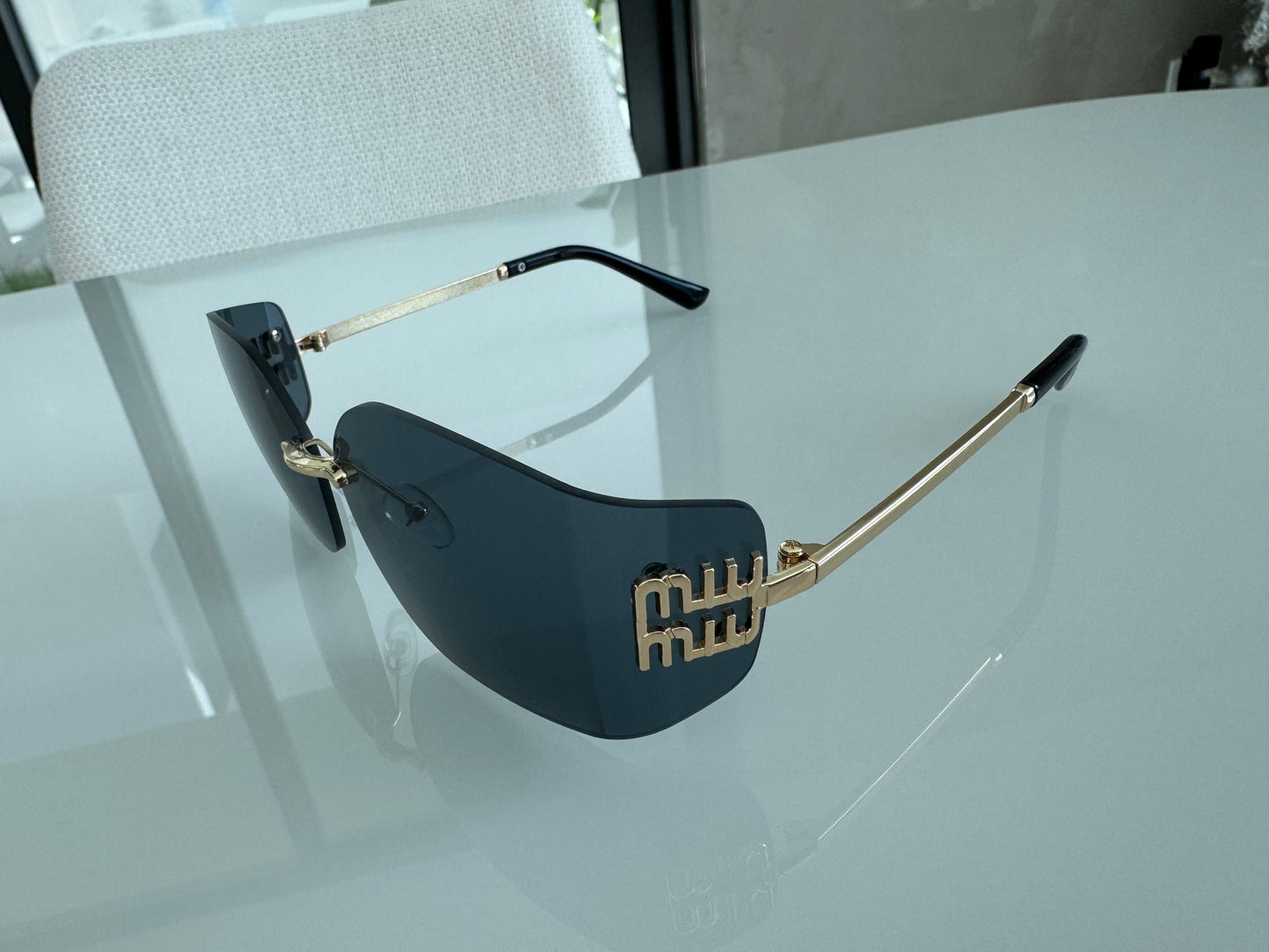 M BLACK AND GOLD SUNGLASSES